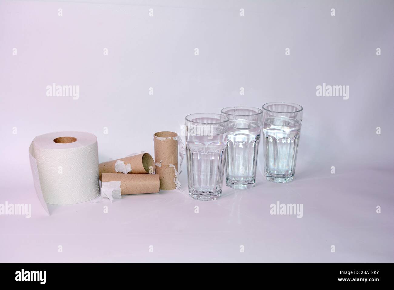 Drink a lot in case of diarrhea - Full and empty toilet paper rolls with  three glasses of water and with copy space Stock Photo - Alamy