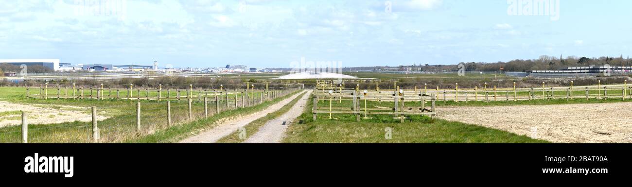 Panoramic view of Gatwick Airport with lots of grounded planes parked and no planes coming in to land or taking off due to a shut down by Covid-19. Stock Photo