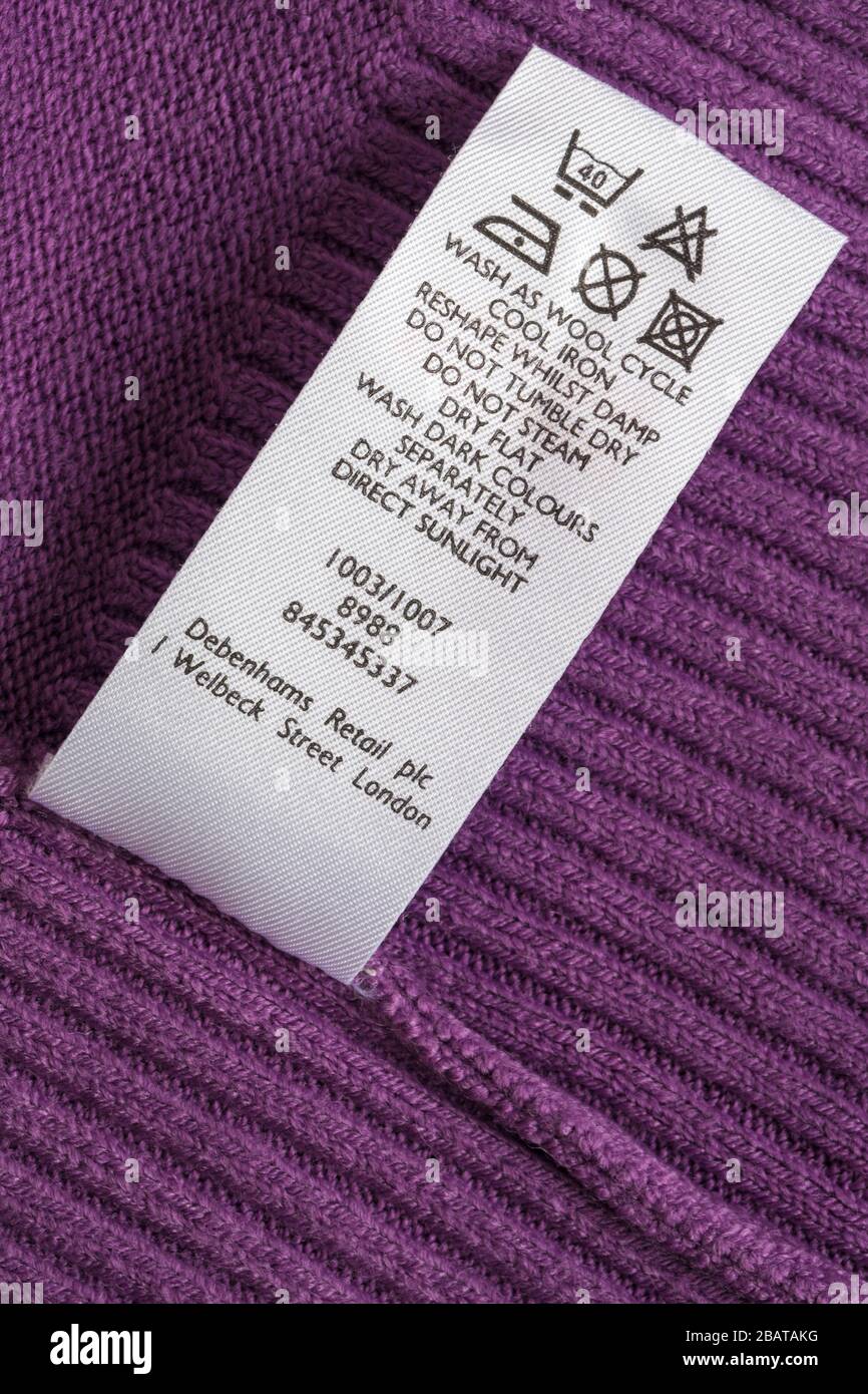 care wash symbols instructions in Debenhams woman's purple mauve top Stock Photo