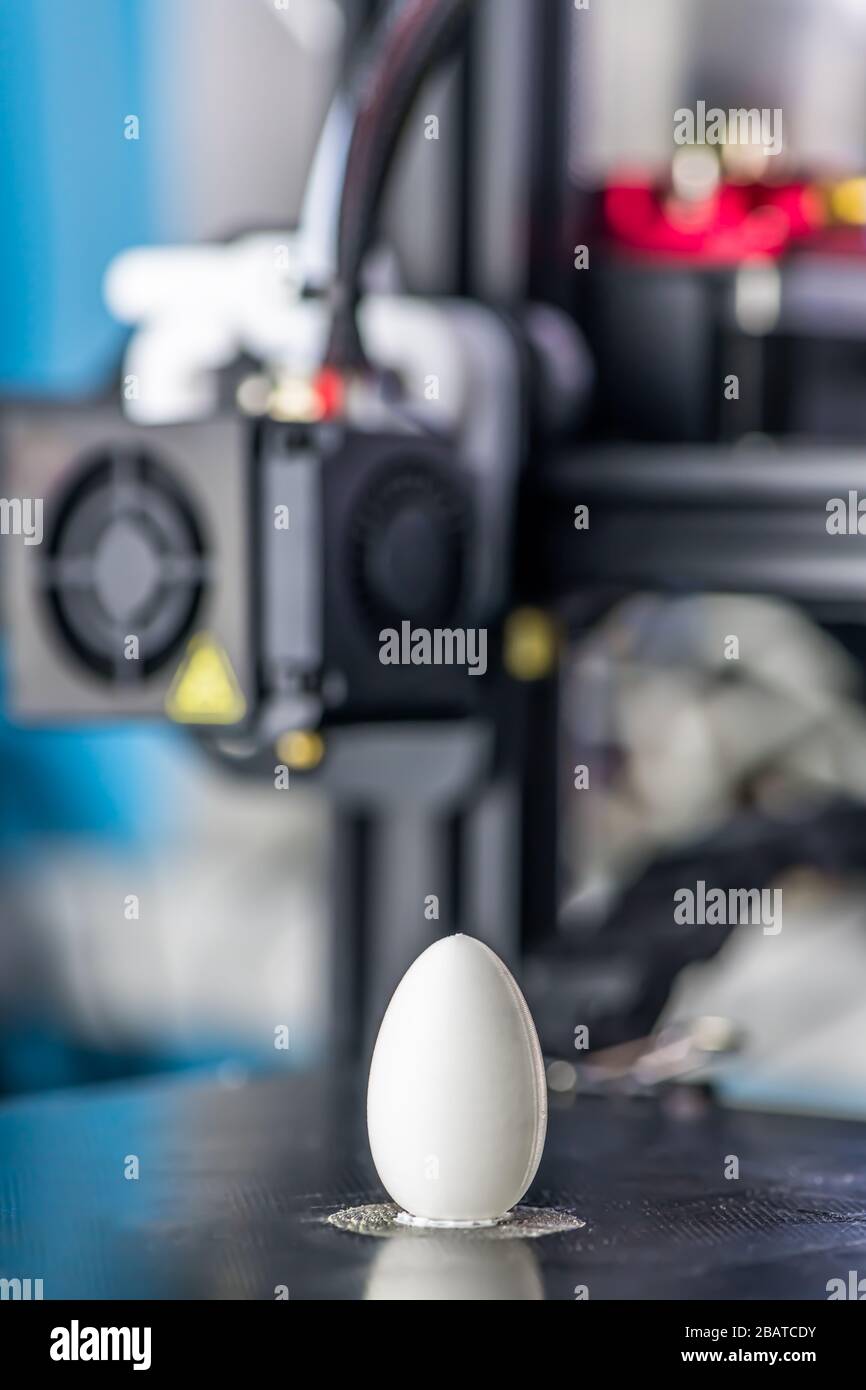 white plastic model of egg printed on a 3D printer. modern technology. Stock Photo