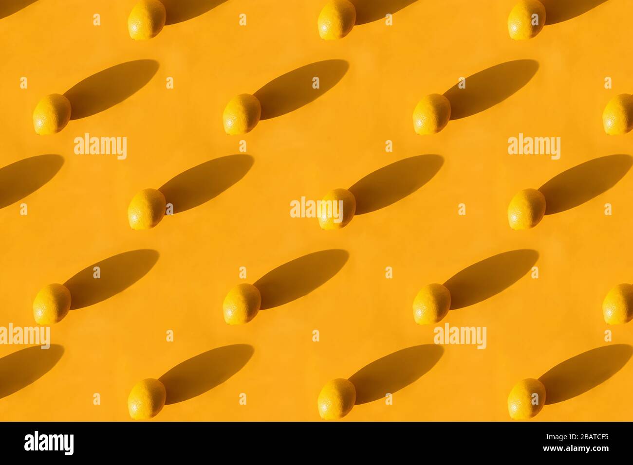 Fresh lemon pattern on a vivid yellow background Stock Photo