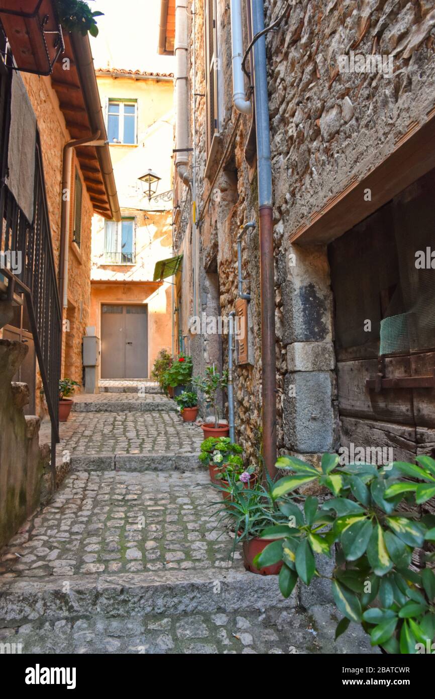 A narrow street between the stone houses of Prossedi, a medieval village in the Lazio region, Italy Stock Photo