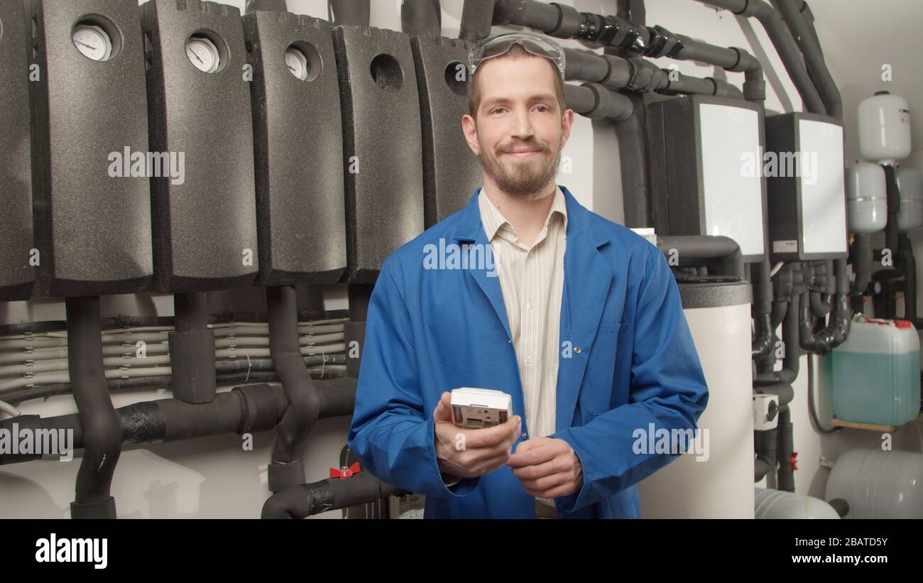 Engineer Camerman Open Young engineer smiling at camera with controller Stock Photo - Alamy