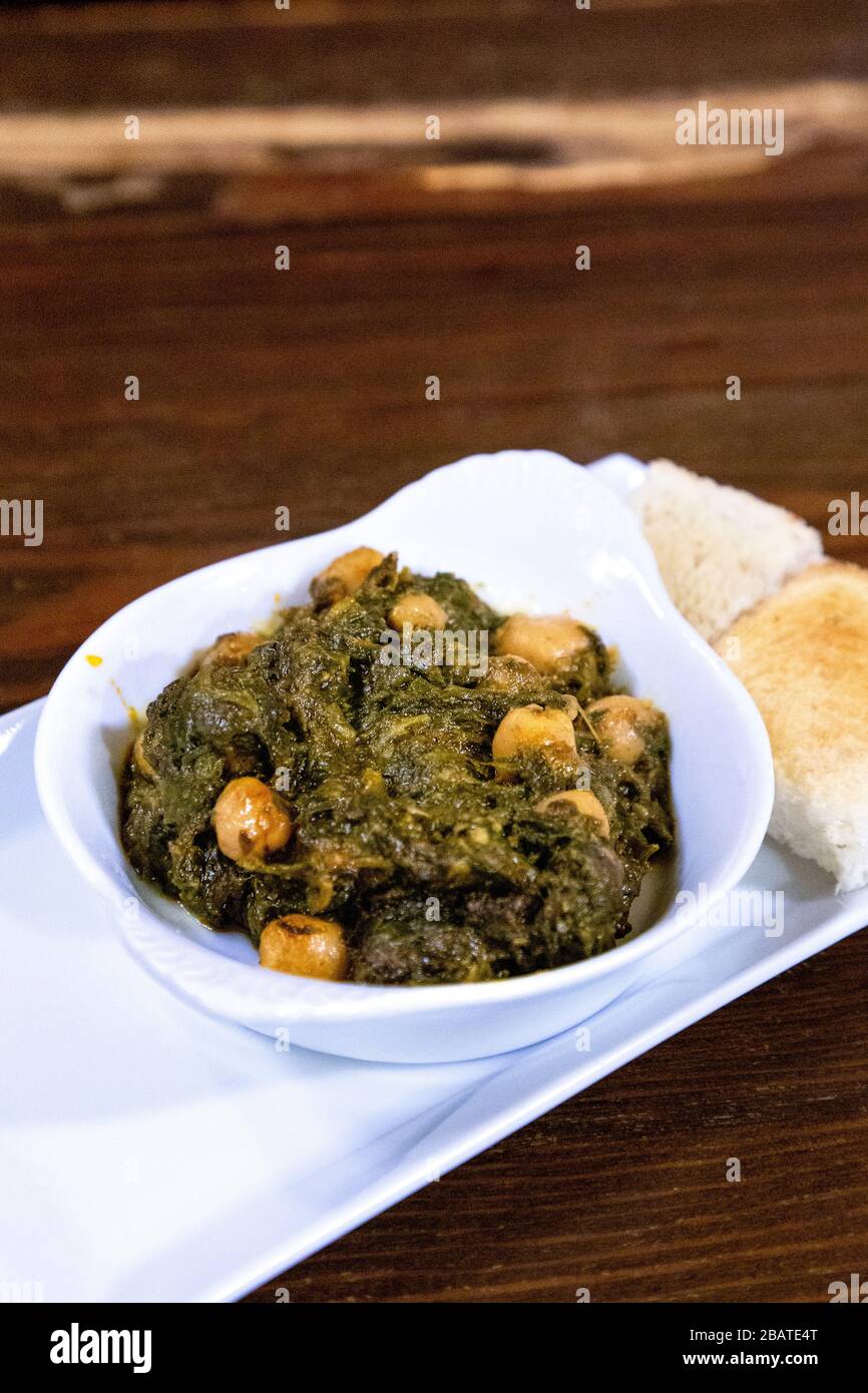 Andalusian cuisine - spinach with chickpeas tapas (Espinacas con Garbanzos) at Casa Morales restaurant, Seville, Andalusia, Spain Stock Photo