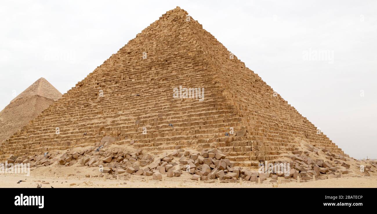 The Pyramid of Menkaure on the Giza Plateau at Cairo, Egypt. The ancient structure stands in front of the Great Pyramid of Giza. Stock Photo
