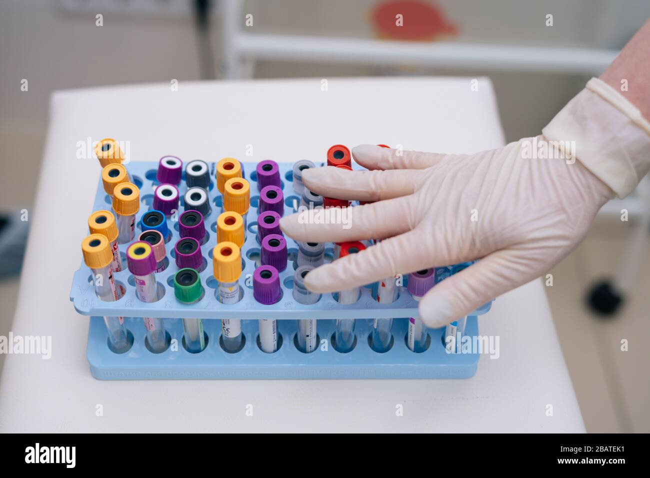 Doctor with rubber gloves put hand on medical blood tube for blood ...