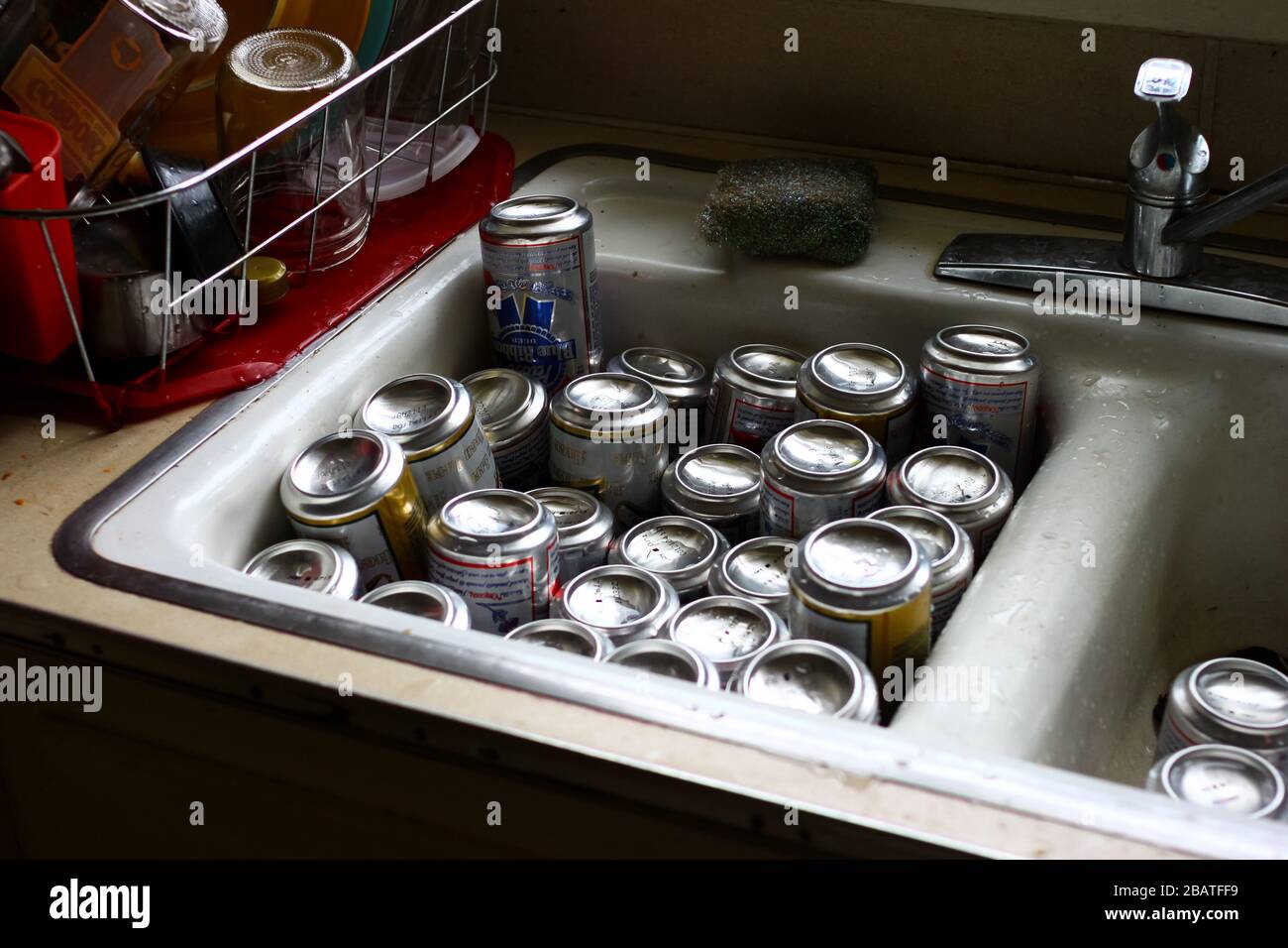 Empty Beer Cans in a Sink after a party in Portland, Oregon, USA Stock Photo
