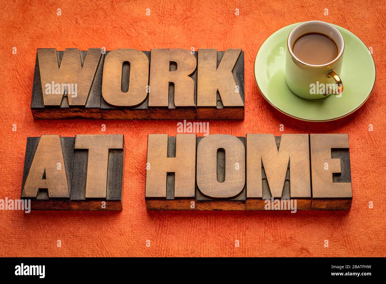 work at home word abstract in wood type with a cup of coffee, social distancing, self quarantine and stay-at-home order during covid-19 coronavirus pa Stock Photo