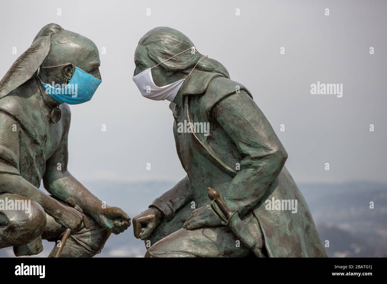 Pittsburgh, PA, USA. 28th Mar, 2020. NEW In response to the COVID-19 virus a clever person put masks on the Seneca leader Guyasuta, left and George Washington. The statue is called, ''Points of View.'' It overlooks the city of Pittsburgh, PA. The city has been in a ''Stay at Home'' order from Governor Wolf since March 23, 2020. The statue marks the westernmost end of he Grand View Scenic Byway, an official Pennsylvania Scenic Byway. Credit: Annie O'Neill/ZUMA Wire/Alamy Live News Stock Photo