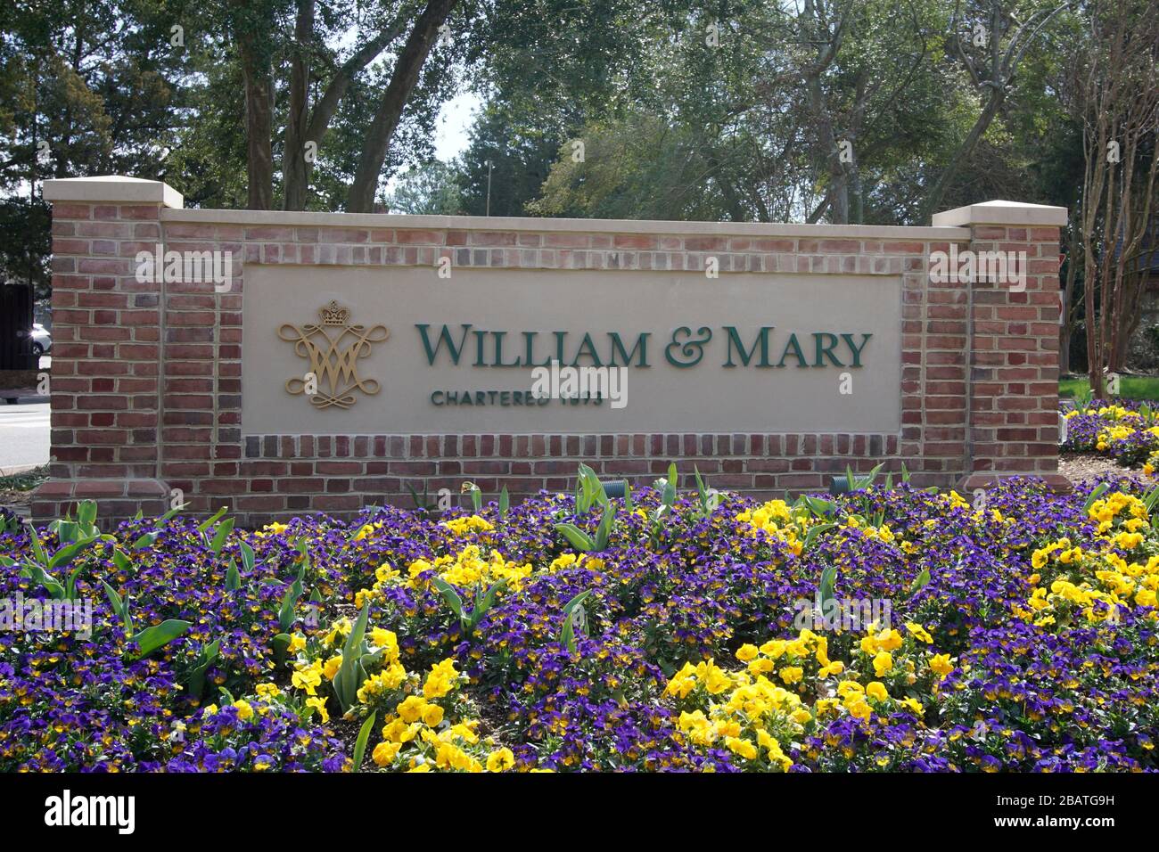 Entrance sign for the College of William & Mary surrounded by flowers. Williamsburg, Virginia / USA Stock Photo