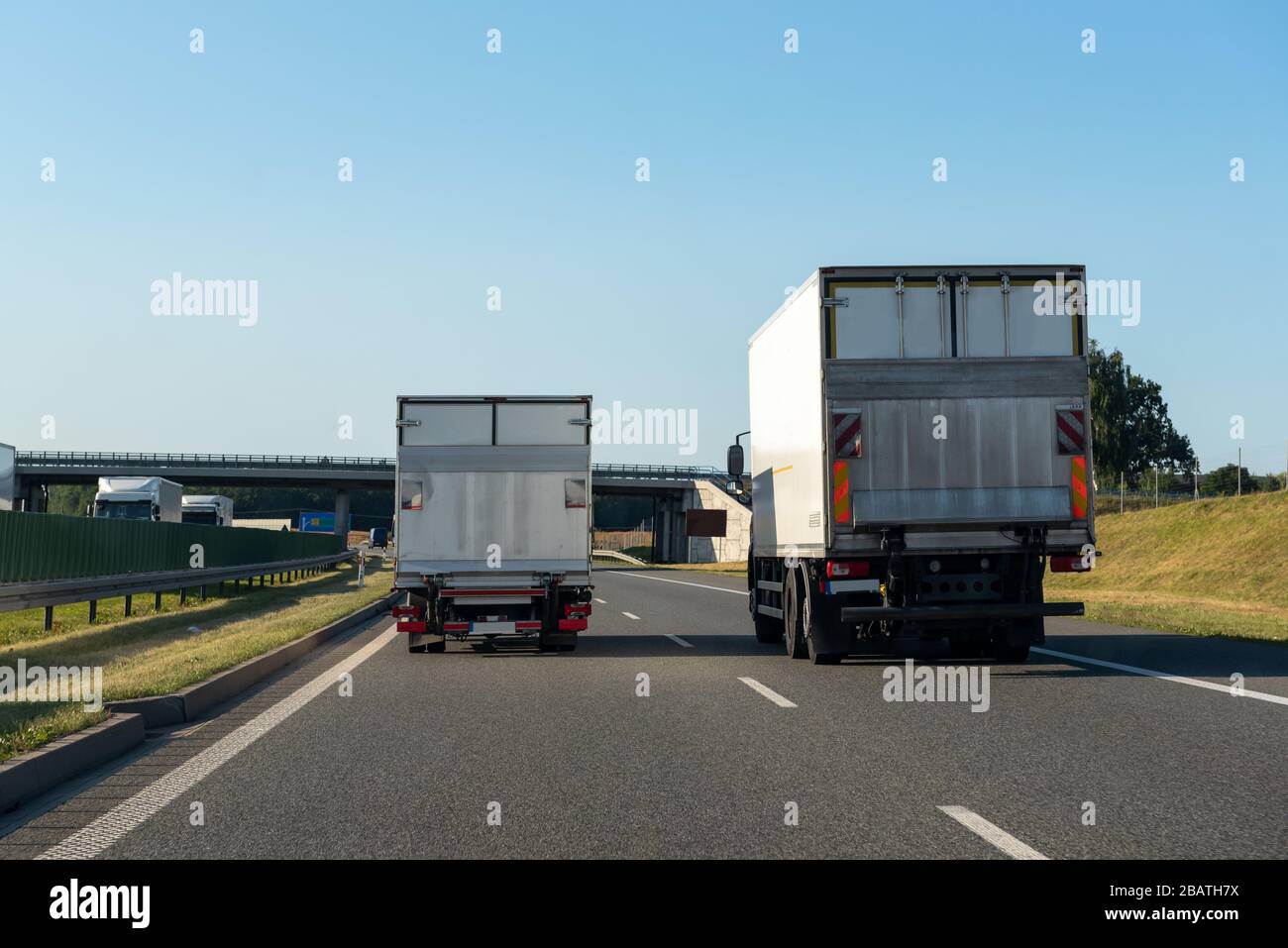 Freight trucks on a highway. Concept of safe driving Stock Photo - Alamy