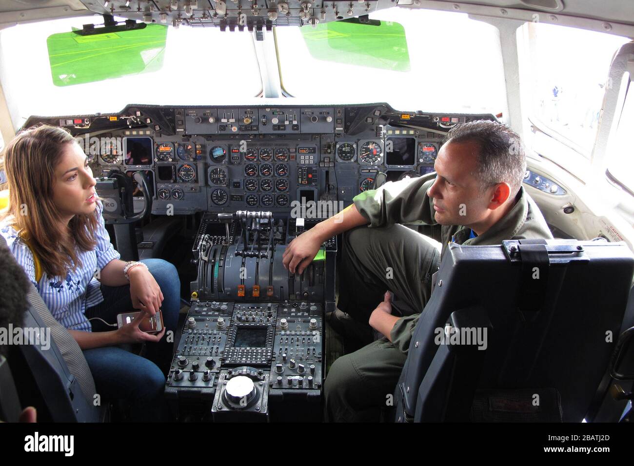 'English: Juanita Gomes, a reporter from Noticias Caracol television in Bogota, interviews U.S. Air Force Senior Master Sgt. Russell Downie, with the 79th Aerial Refueling Squadron from Travis Air Force Base, Calif., in the cockpit of a KC-10 during the Colombian Air Force’s Feria Aeronautica Internaccional – Colombia in Rionegro,  July 14, 2017. The United States Air Force is participating in the four-day air show with two South Carolina Air National Guard F-16s as static displays, plus static displays of a KC-135, KC-10, along with an aerial demonstration by the Air Combat Command’s Viper Ea Stock Photo
