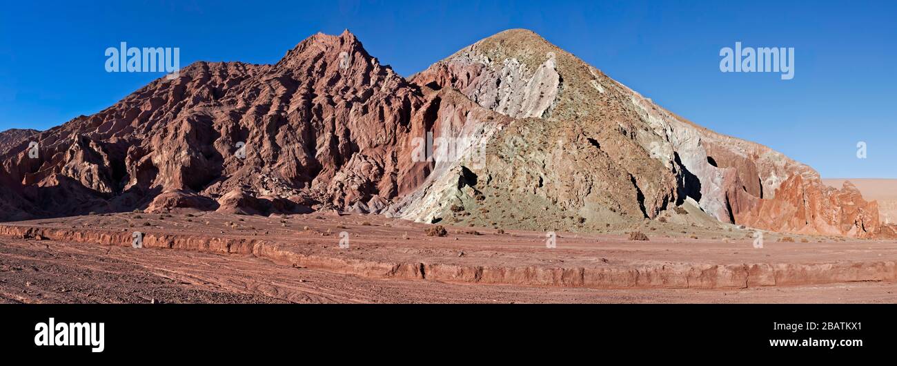 Panorama of the many colors of igneous rock in Rainbow Valley (red, orange, brown, green, white), Atacama Desert, Chile Stock Photo