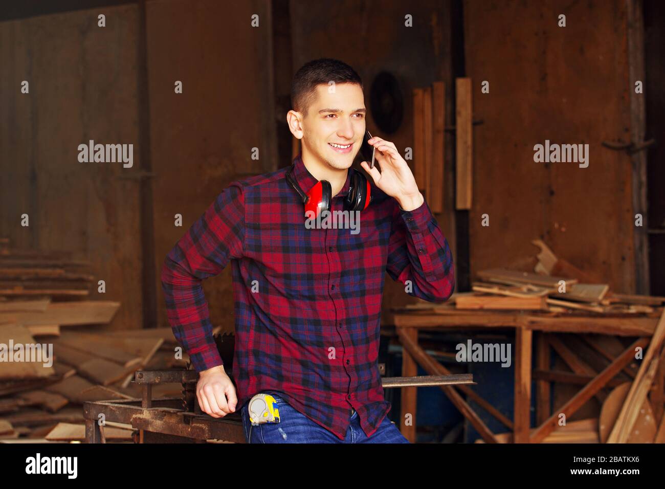 Workman at the sawmill. Young hardworking man Stock Photo