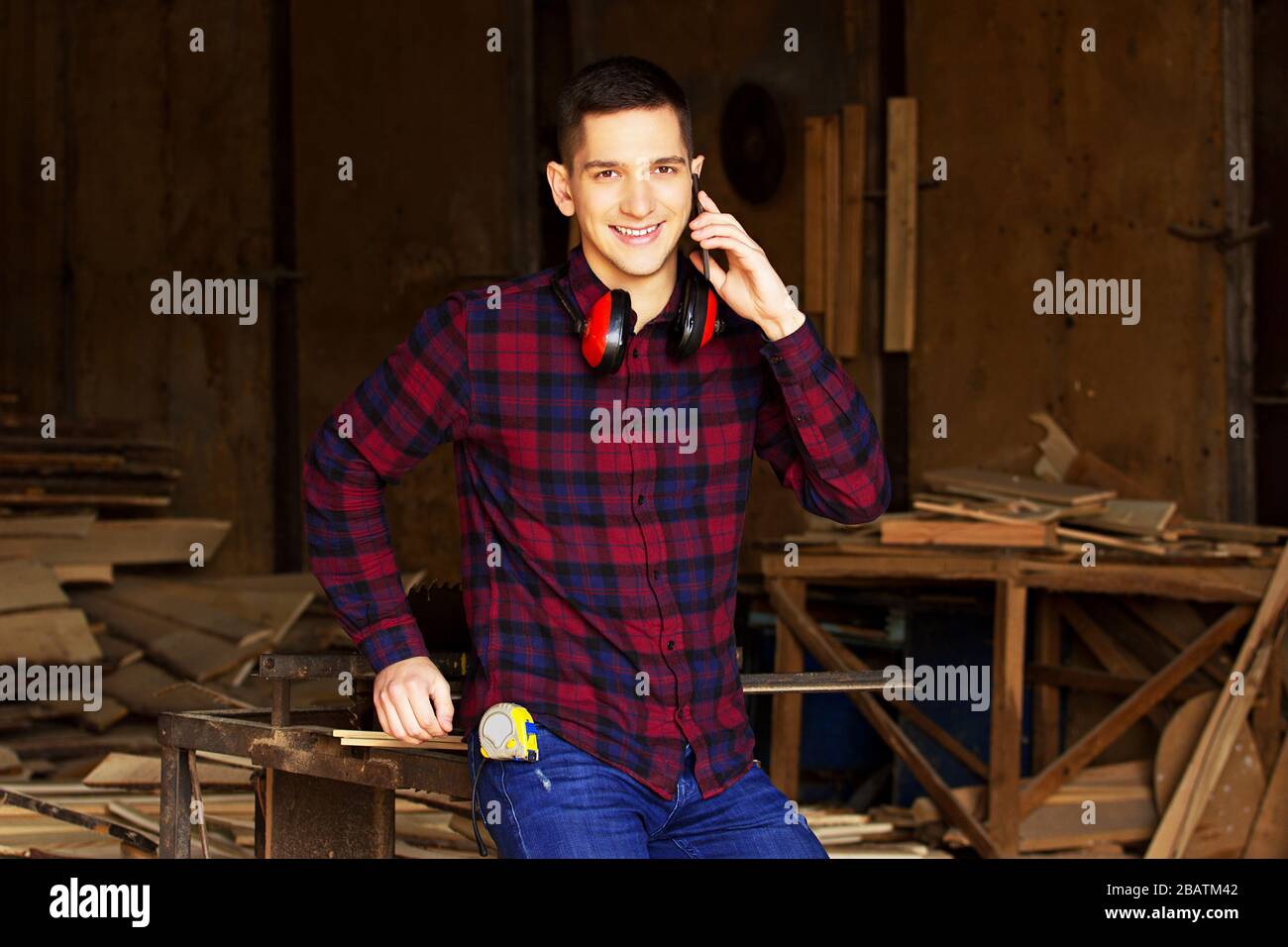 Workman at the sawmill. Young hardworking man Stock Photo