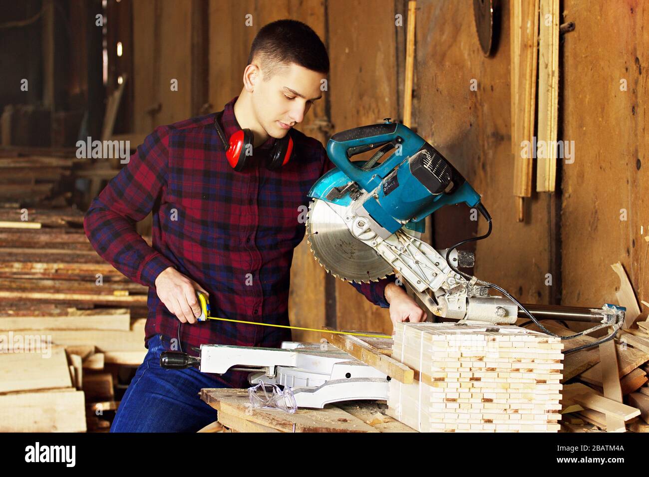 Workman at the sawmill. Young hardworking man Stock Photo