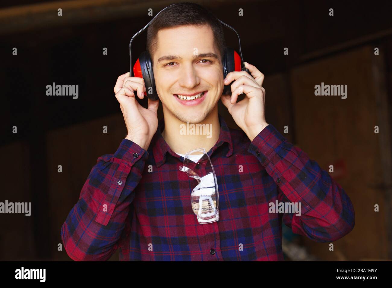 Workman at the sawmill. Young hardworking man Stock Photo