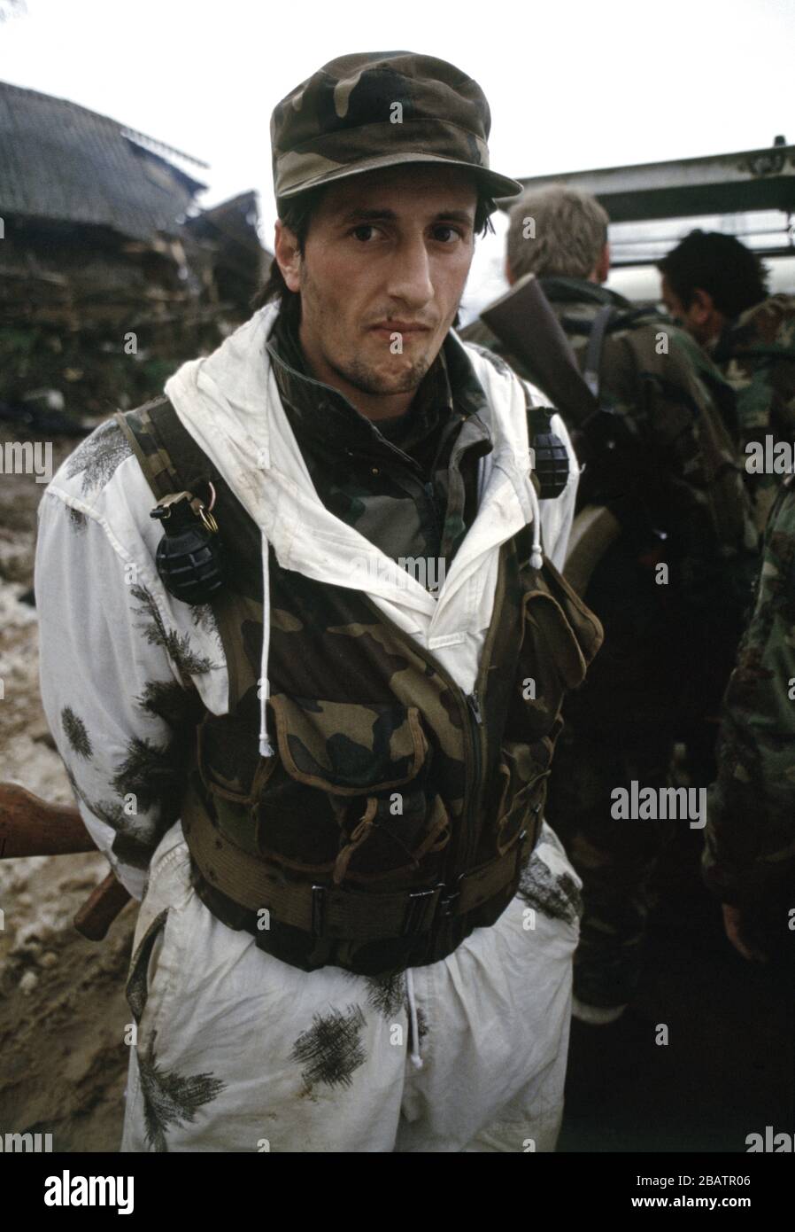 26th January 1994 During the war in central Bosnia: a soldier of the HVO's Rama Brigade wearing a snow camouflage oversuit in the Bosnian Muslim village of Here, which was captured two days earlier. Stock Photo