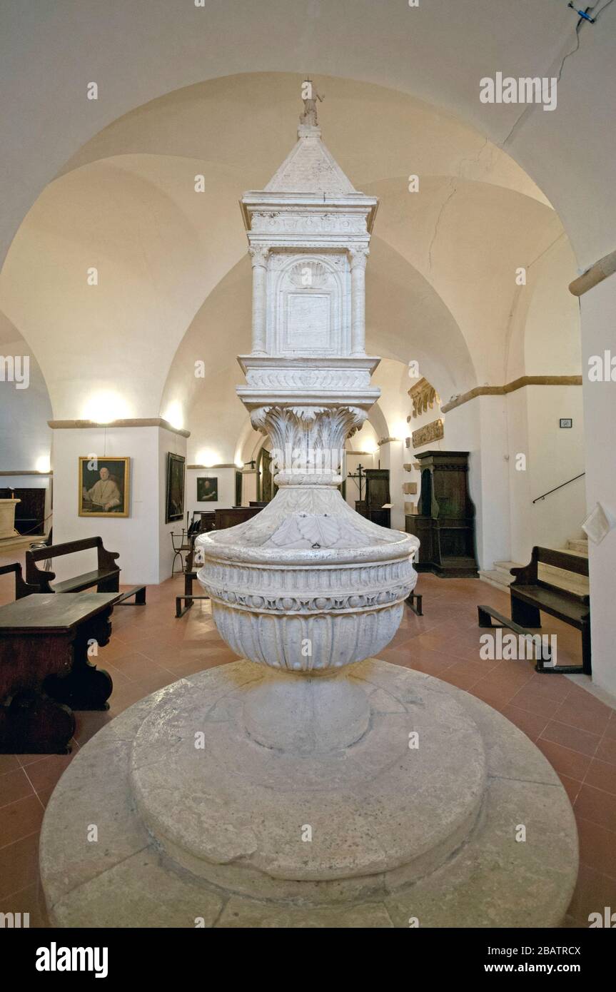 Baptismal font by studio of Bernardo Rossellino in St John Church (located under the apse of the Duomo), Pienza, Tuscany, Italy Stock Photo