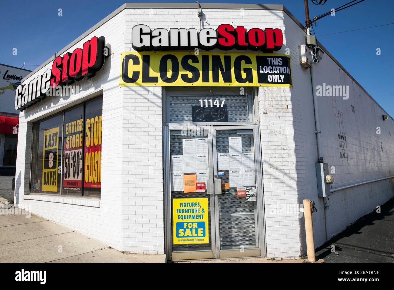'Store Closing" signs outside of a GameStop retail store location in Wheaton, Maryland on March 26, 2020. Stock Photo