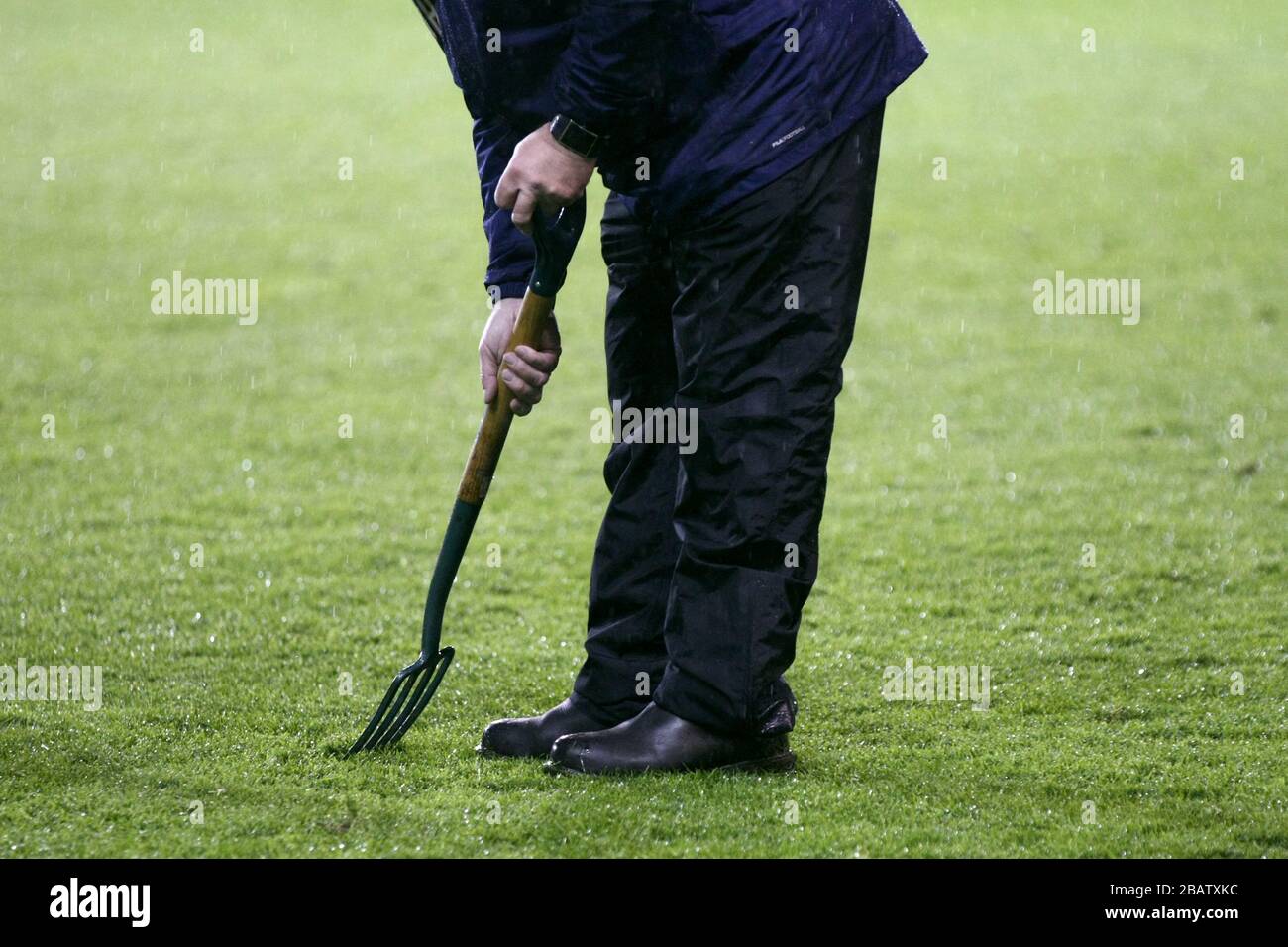 A Blackpool groundsman tends to the pitch before the game Stock Photo
