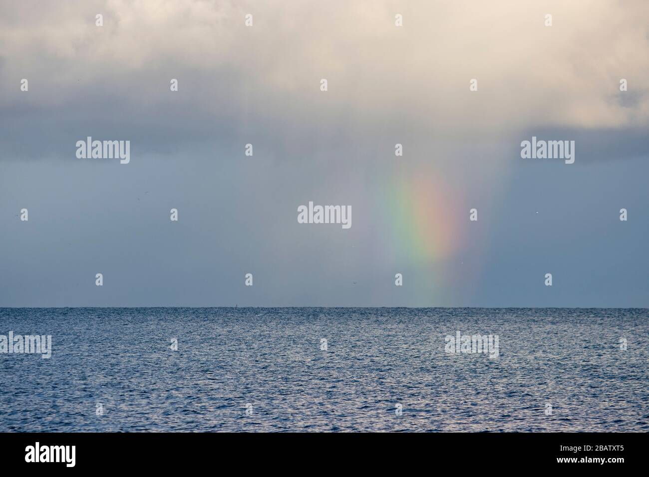Rainbow clouds rain sun blue sky hi-res stock photography and images ...