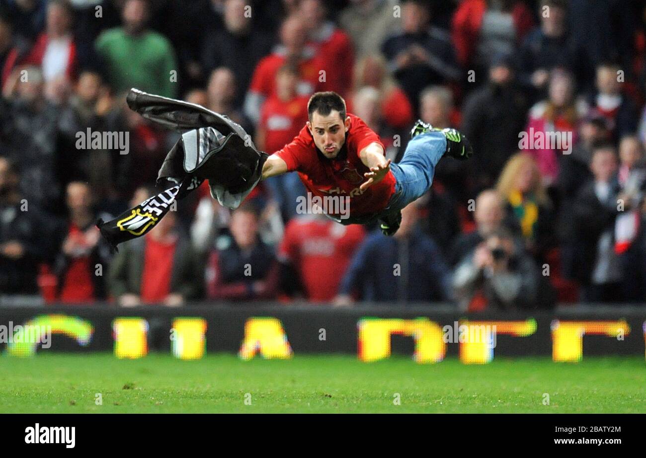 A Pitch Invader dives onto the pitch Stock Photo