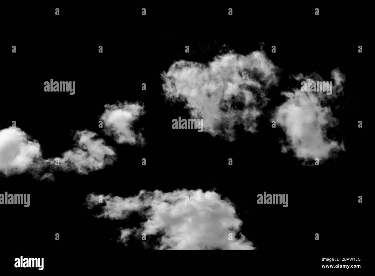 Real white and grey clouds isolated on black background. White fluffy clouds on dark background. Stock Photo