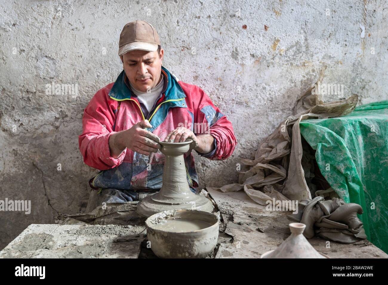 A potter makes ceramic pots at Art Naji pottery factory, Fes, Morocco