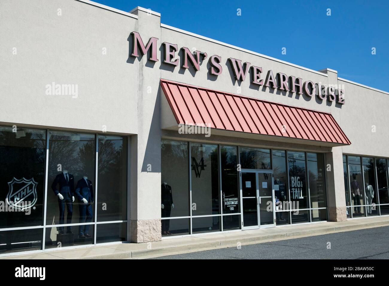 A logo sign outside of a Men's Wearhouse retail store location in