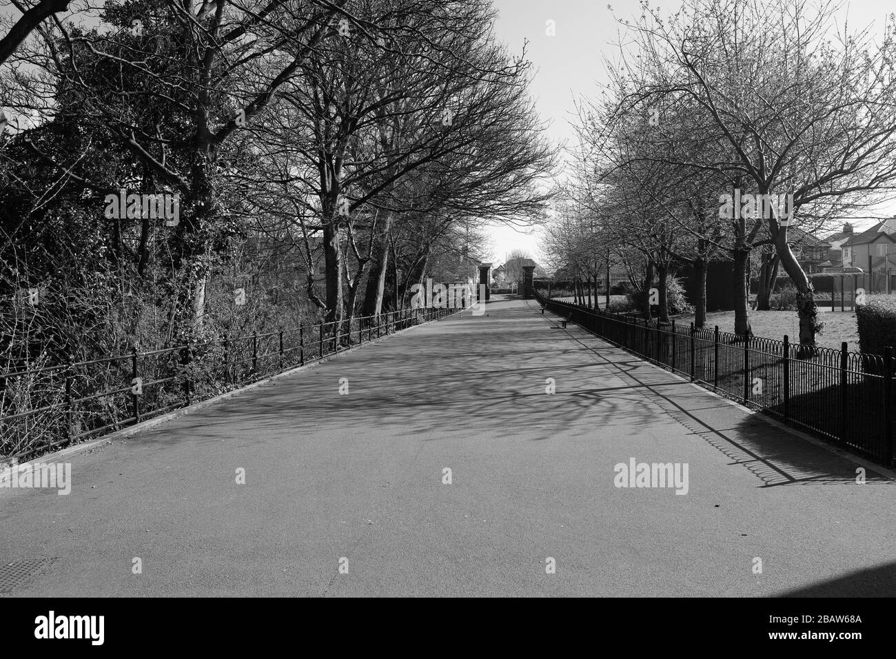 Derby Park in Bootle Liverpool is almost deserted and the children's play area closed. People keep their distance at the supermarket due to COVID-19. Stock Photo