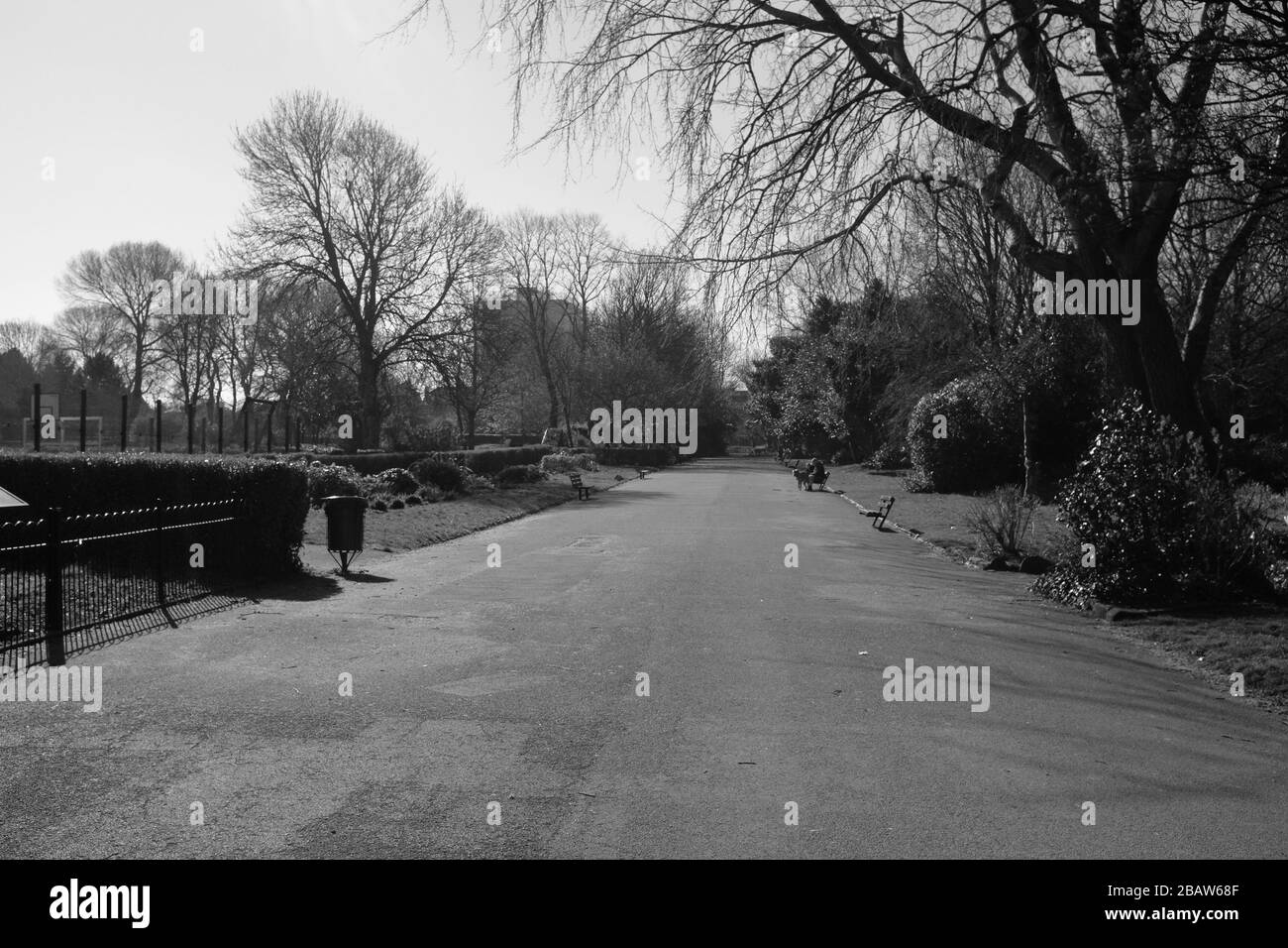 Derby Park in Bootle Liverpool is almost deserted and the children's play area closed. People keep their distance at the supermarket due to COVID-19. Stock Photo