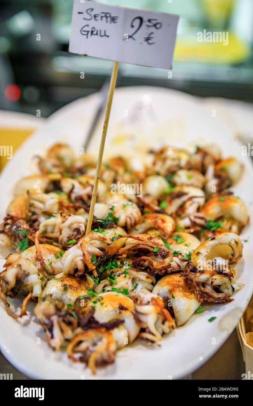 Traditional Italian street food in Venice - fried baby calamari on display on a plate at a stall with a price tag of 2.5 EUR Stock Photo