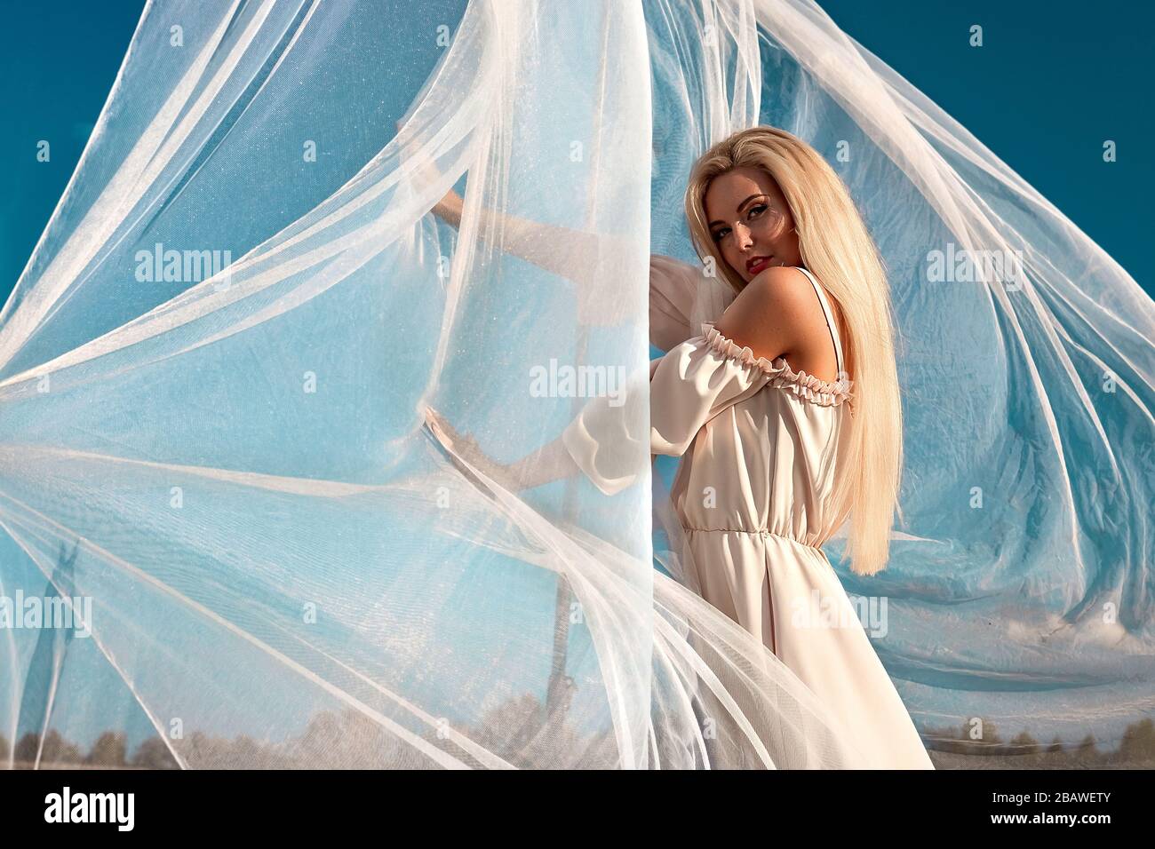 Portrait of a beautiful girl, blonde with long hair in the field, after ...