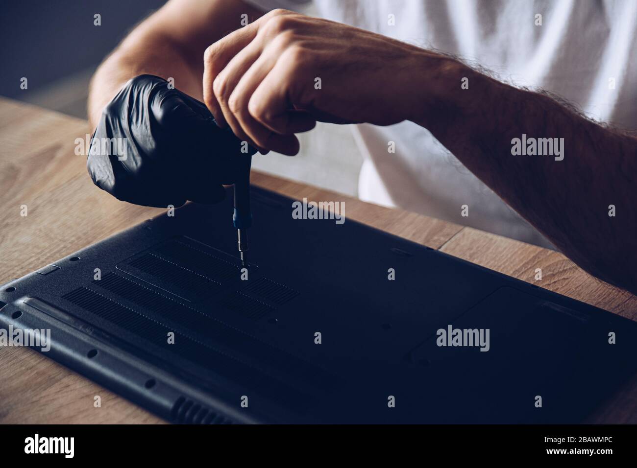 Technician installing new RAM module into the memory slot Stock Photo