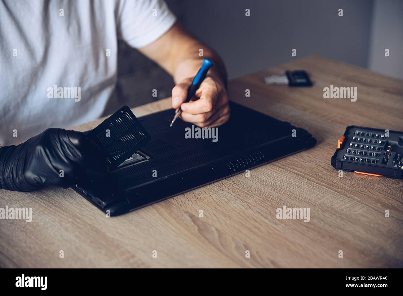 Technician installing new RAM module into the memory slot Stock Photo