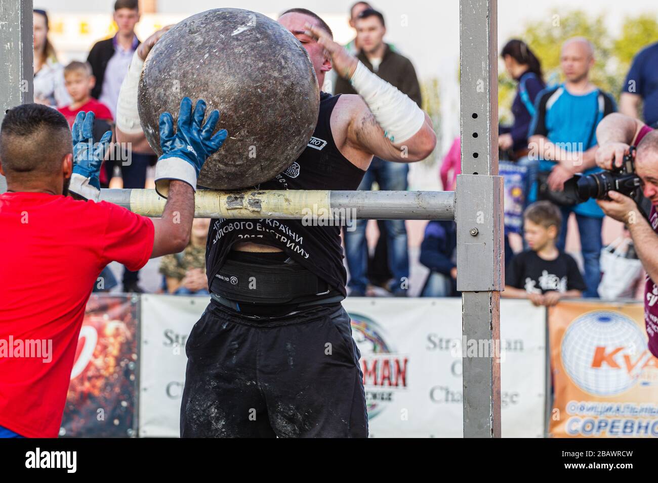 Melitopol, Ukraine, date May 27, 2017, Strongman throws a heavy ball of