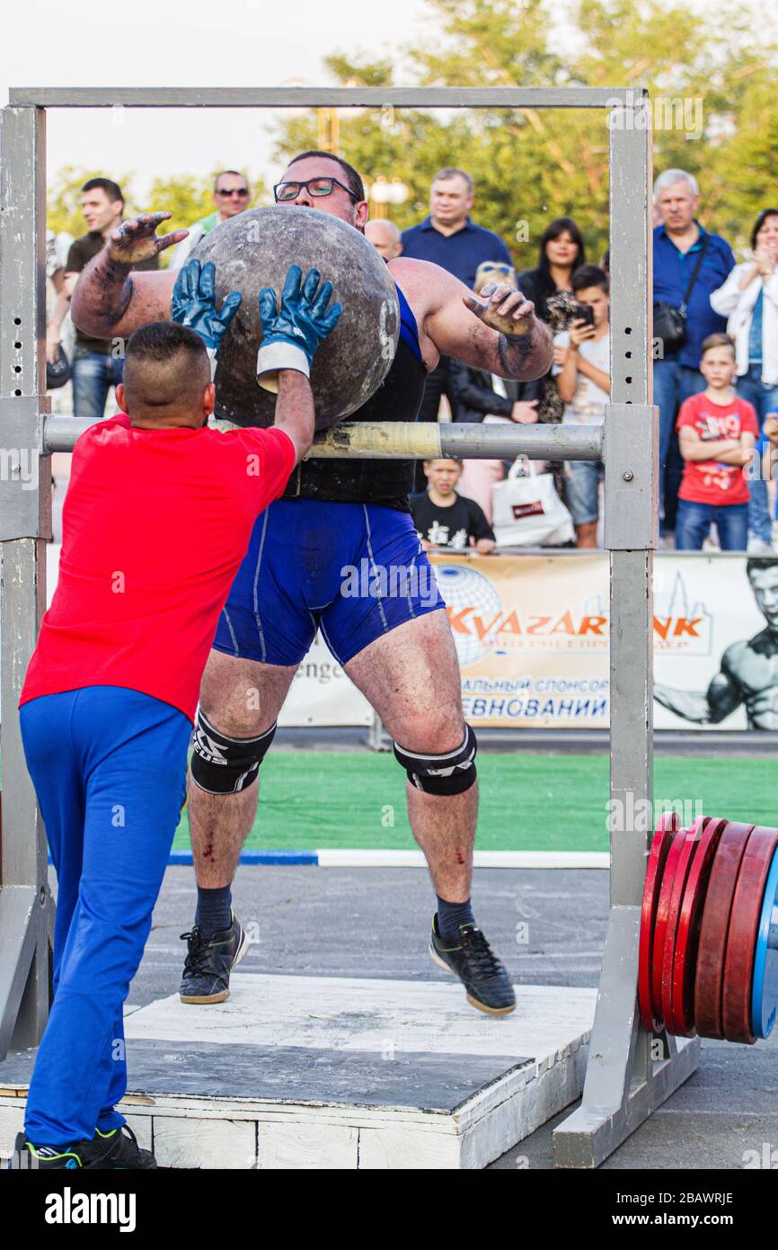 Melitopol, Ukraine, date May 27, 2017, Strongman throws a heavy ball of