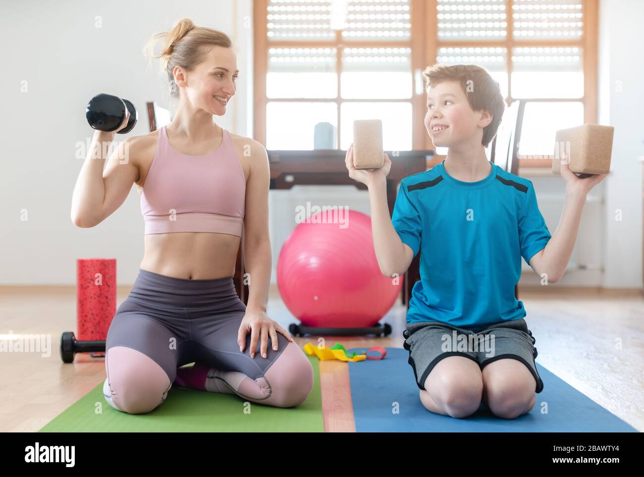 Mother and son doing weight training at home during lockdown curfew