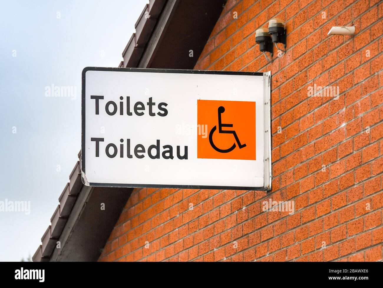 MID-WALES, GREAT BRITAIN - JULY 2018: Sign on the outside of a building, The English translation of the Welsh words 'Toiledau' is 'Toilets'. Stock Photo