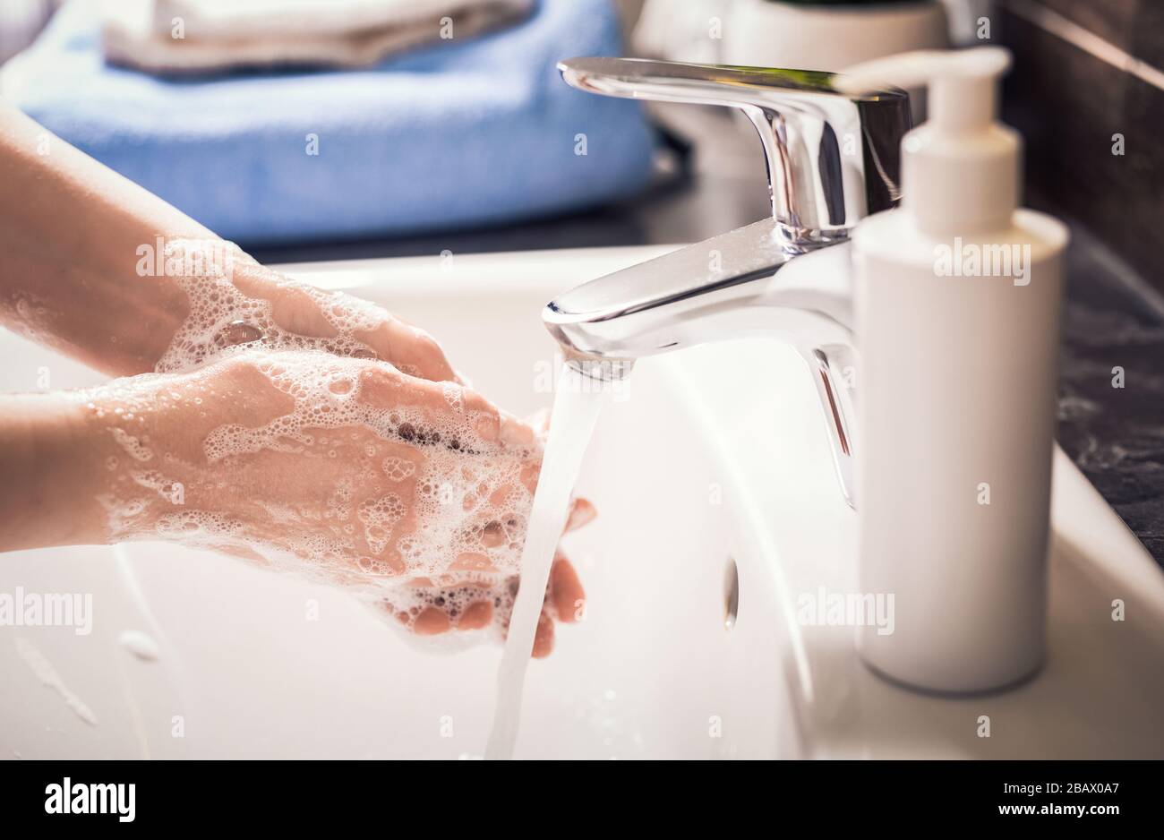 Washing hands with soap and hot water. Prevention coronavirus. Corona Virus (covid 19) pandemic protection by washing hands. Stock Photo