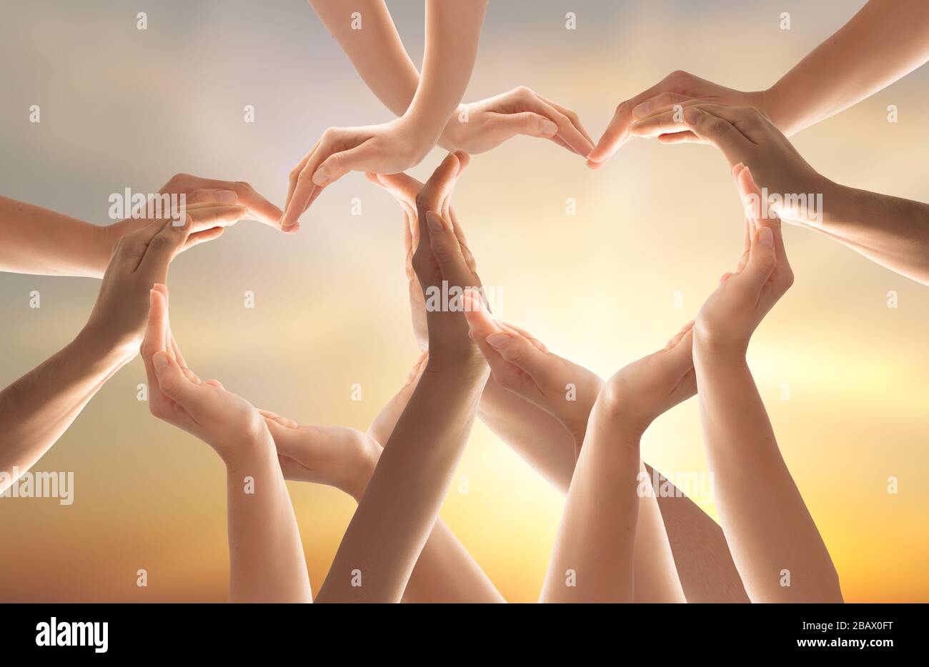 Symbol and shape of heart created from hands.The concept of unity, cooperation, partnership, teamwork and charity. Stock Photo