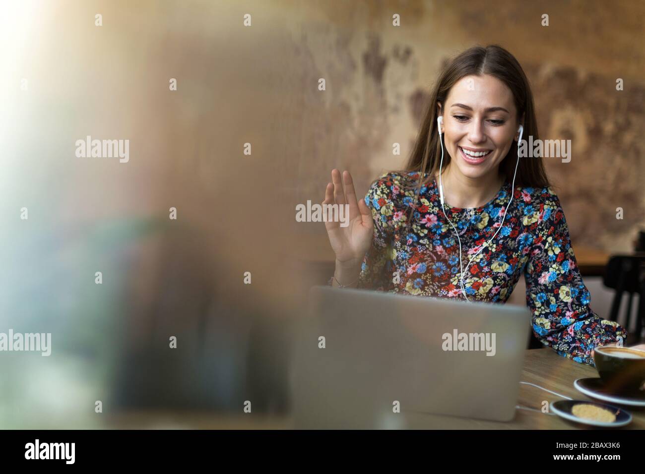 Young woman with laptop in cafe Stock Photo - Alamy