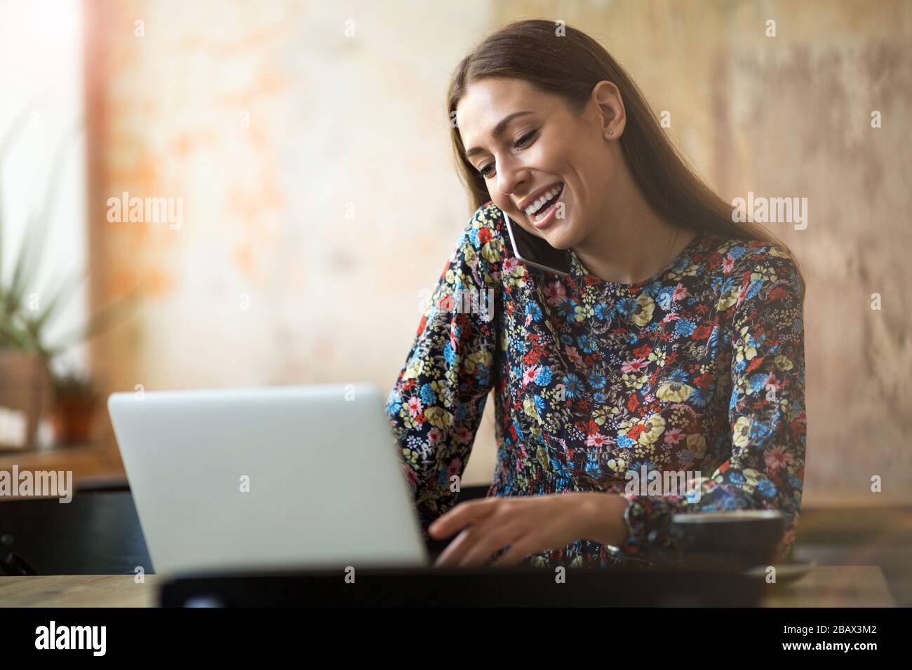 Young woman with laptop in cafe Stock Photo