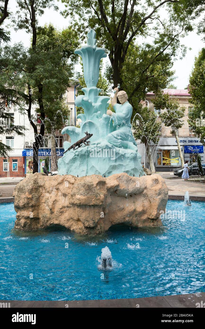 TUAPSE, RUSSIA-CIRCA JUL, 2018: Sculptures of lizzard and stone-cutting master are in bowl of fountain the Stone Flower. Heroes of fairy tales by Pave Stock Photo