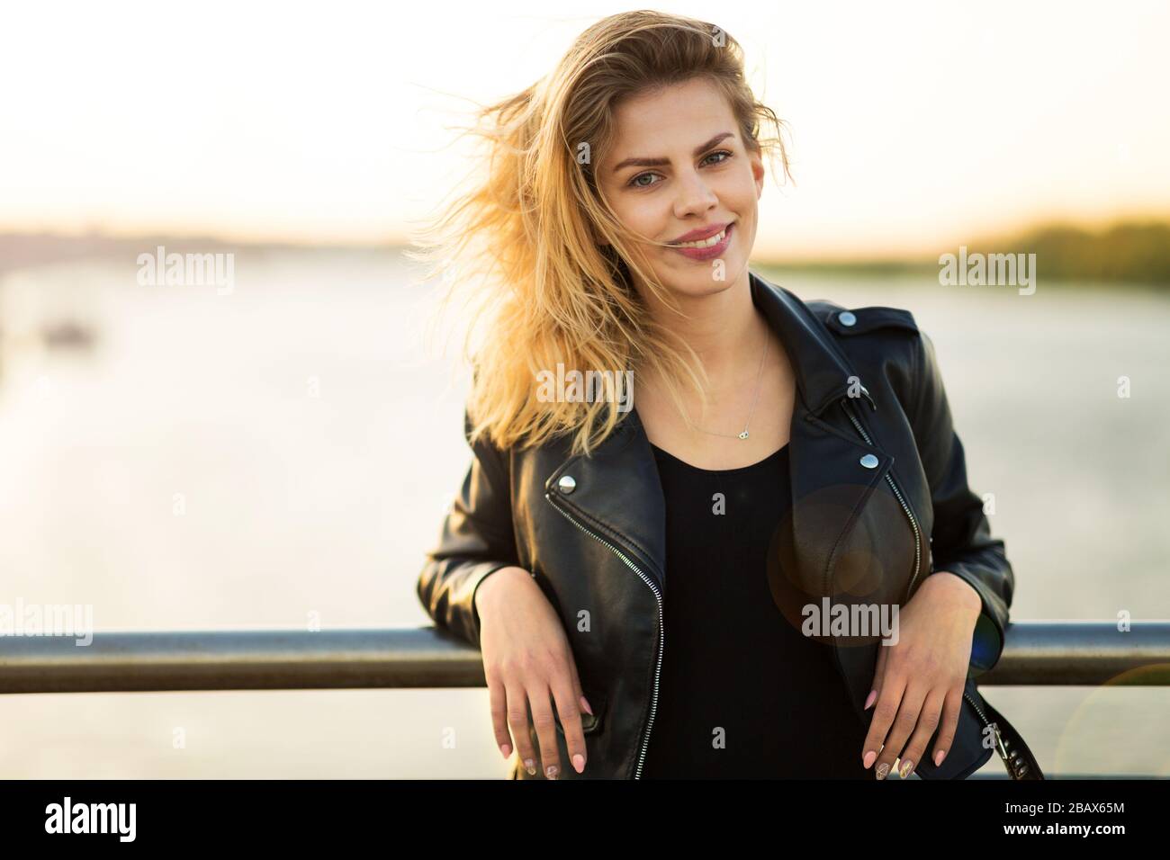 Portrait of a beautiful smiling young woman sitting at meal table Stock ...