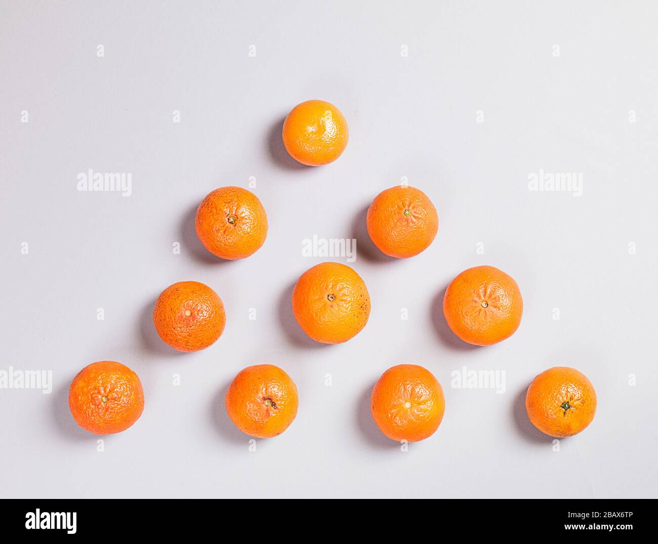 Three Fresh Oranges on Grey Background Stock Photo