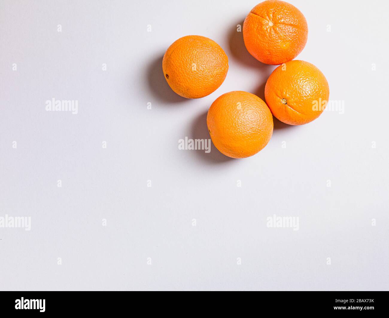 Three Fresh Oranges on Grey Background Stock Photo