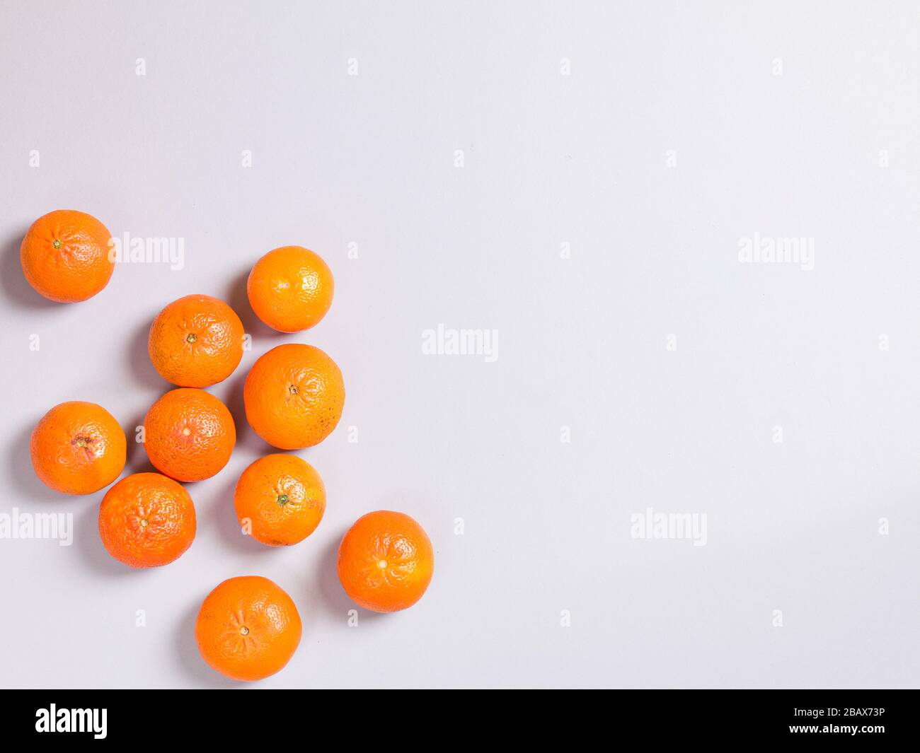 Three Fresh Oranges on Grey Background Stock Photo