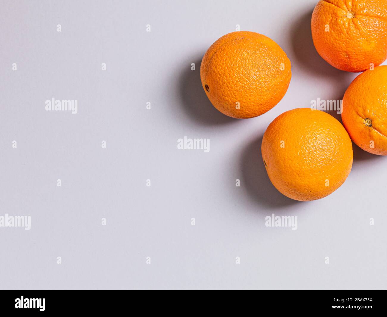 Three Fresh Oranges on Grey Background Stock Photo